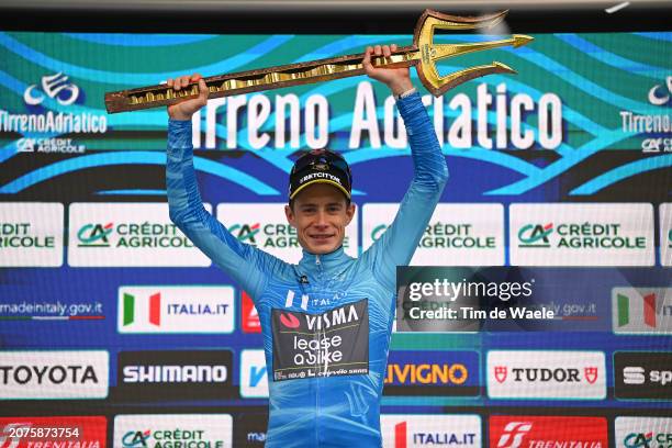 Jonas Vingegaard Hansen of Denmark and Team Visma-Lease A Bike celebrates at podium as race winner and Blue Leader Jersey with Trident Race Trophy...