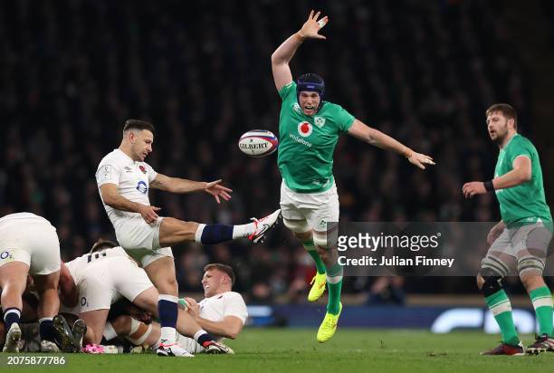 Danny Care of England kicks the ball as Ryan Baird of Ireland attempts to charge down during the Guinness Six Nations 2024 match between England and...
