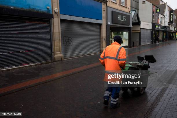 Street cleaner walks through Middlesbrough town centre on March 11, 2024 in Middlesbrough, England. UK High Streets are suffering further losses this...