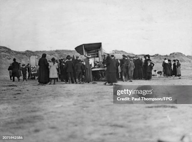 Small crowd gathers around the Wright Biplane in which British aviator Alec Ogilvie made his record flight, on Camber Sands, a beach near Camber,...
