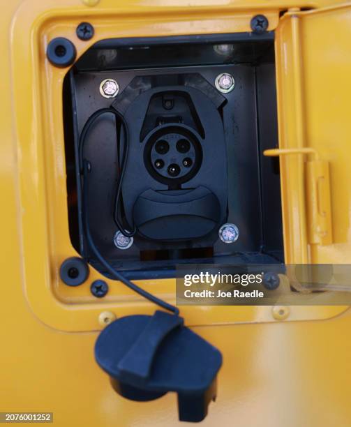 The charging plug is seen on a Miami-Dade electric school bus as U.S. Environmental Protection Agency Administrator Michael S. Regan visits during an...