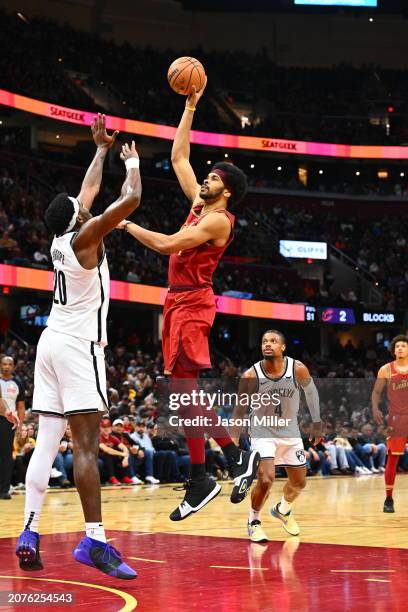 Jarrett Allen of the Cleveland Cavaliers shoots over Day'Ron Sharpe of the Brooklyn Nets d4q at Rocket Mortgage Fieldhouse on March 10, 2024 in...