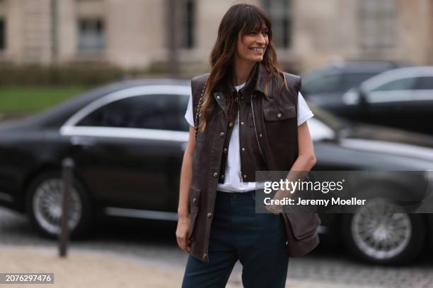 Fashion Week Guest seen wearing a brown leather vest, blue pants, white shirt and silver bracelets and black Chanel handbag outside Chanel show,...