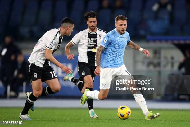 Ciro Immobile of SS Lazio runs with the ball whilst under pressure from Nehuen Perez of Udinese Calcio during the Serie A TIM match between SS Lazio...