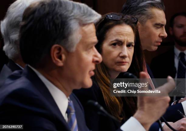 Director of National Intelligence Avril Haines listens to Federal Bureau of Investigation Director Christopher Wray testify before the Senate Select...