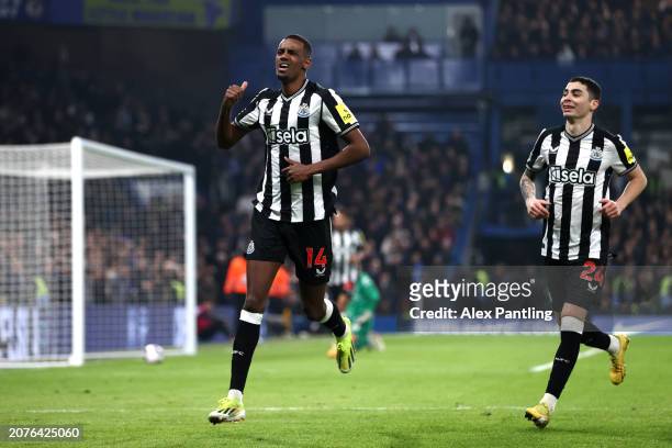 Alexander Isak of Newcastle United celebrates scoring his team's first goal with teammate Miguel Almiron during the Premier League match between...