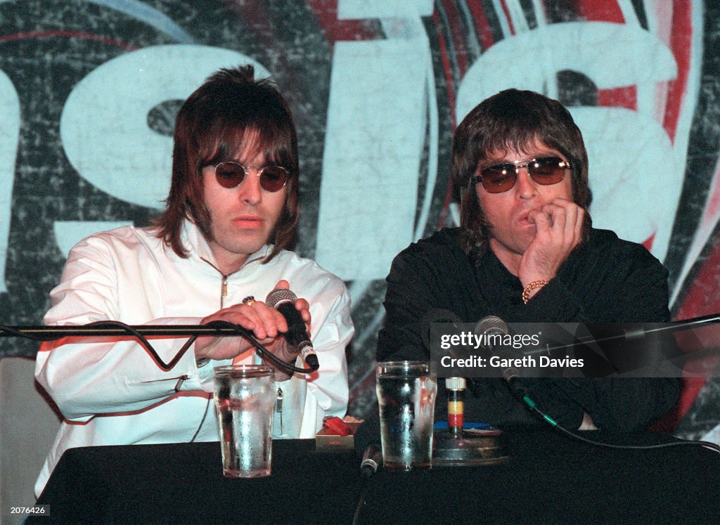 Oasis band members Liam and Noel Gallagher at a press conference