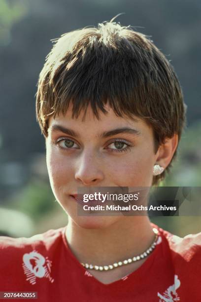 German actress and model Nastassja Kinski, wearing a red top, with heart-shaped earrings, United States, December 1980.