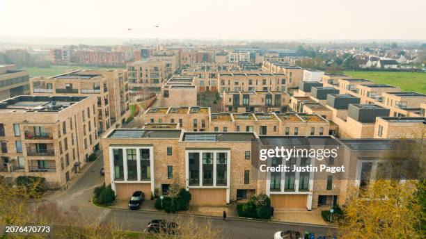 drone view of a newly built residential district in cambridge, uk - green roof stock pictures, royalty-free photos & images