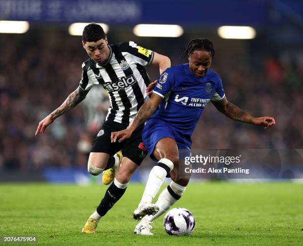 Raheem Sterling of Chelsea holds off Miguel Almiron of Newcastle United during the Premier League match between Chelsea FC and Newcastle United at...