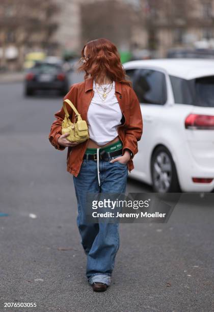 Marie Gaguech seen wearing seen wearing Miu Miu brown glasses, a orange leather jacket, a white t-shirt, gold jewellry, Miu Miu yellow bag, Miu Miu...