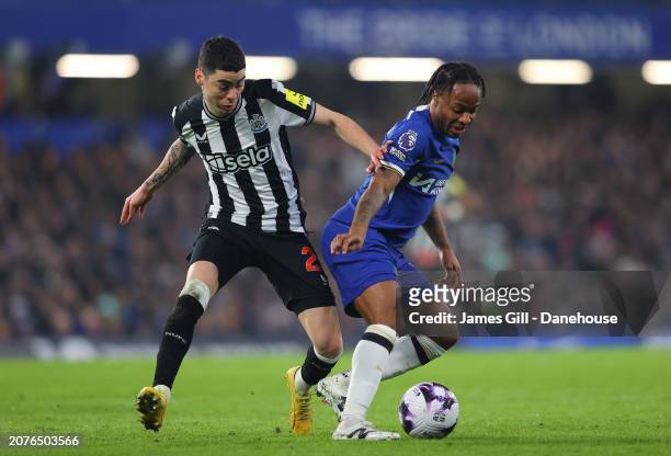 Raheem Sterling of Chelsea FC holds off a challenge from Miguel Almiron of Newcastle United during the Premier League match between Chelsea FC and...