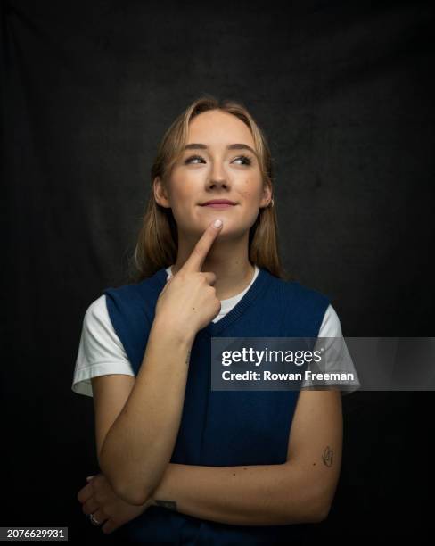 portrait of a thoughtful young woman with hand on chin - tank top stock pictures, royalty-free photos & images