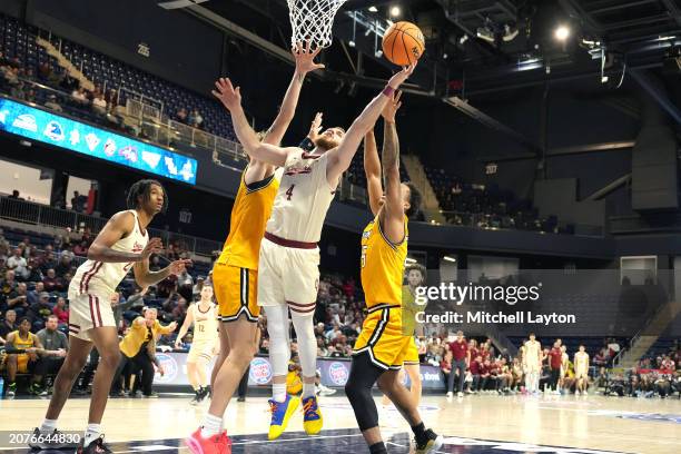 Bryce Butler of the Charleston Cougars drives to the basket in the first half during the semifinal round of the CAA Mens Basketball Tournament...