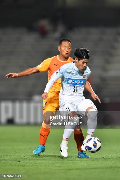 Takumi Miyayoshi of Consadole Sapporo controls the ball against Jong Tae-se of Shimizu S-Pulse during the J.League YBC Levain Cup Group B match...