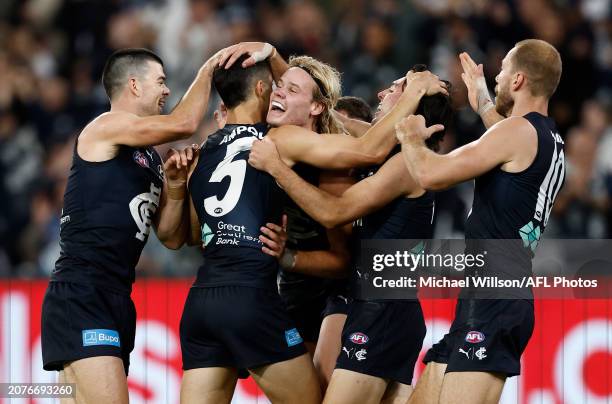 Tom De Koning of the Blues celebrates with teammates during the 2024 AFL Round 01 match between the Carlton Blues and the Richmond Tigers at the...