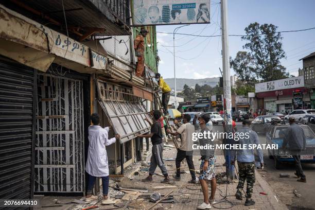 People dismantle a jewellery shop during a planned demolition in the historical Piazza neighbourhood of Addis Ababa on March 14, 2024. The city of...