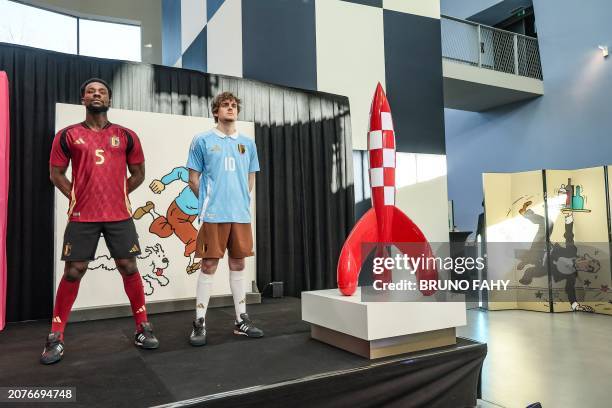 Two models show the home and away outfits, during a press conference of Belgian national soccer team Red Devils to present the new shirts for the...