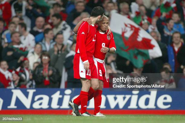 February 18: Ryan Giggs of Wales and Robert Earnshaw of Wales celebrate during the International Friendly match between Wales and Scotland at...