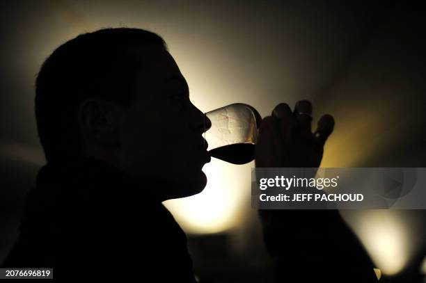 Man tests wine during the 149th edition of the Hospices de Beaune charity auction wine sale, on November 15, 2009 in Beaune, central France. The...