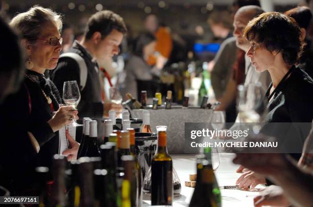 Visitors taste some wine during the third edition of "Omnivore Food Festival" , on February 11, 2008 in Deauville. Around 50 chefs participate in...