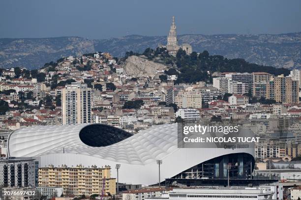 This photograph taken on March 14, 2024 shows a view of Marseille, southern France, with the Velodrome stadium. Marseille will host matches of the...