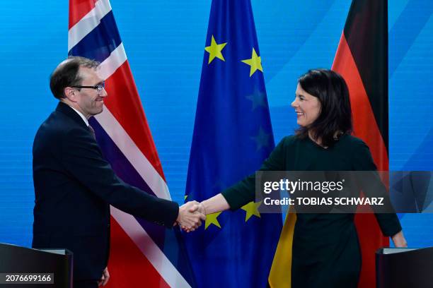 Norwegian Foreign Minister Espen Barth Eide and German Foreign Minister Annalena Baerbock shake hands after addressing a joint press conference at...