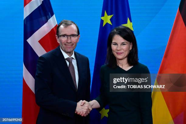 Norwegian Foreign Minister Espen Barth Eide and German Foreign Minister Annalena Baerbock shake hands after addressing a joint press conference at...