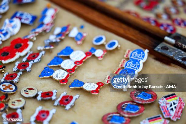 Rangers enamel pin badges being sold at a merchandise stall ahead of the UEFA Europa League 2023/24 round of 16 second leg match between Rangers FC...