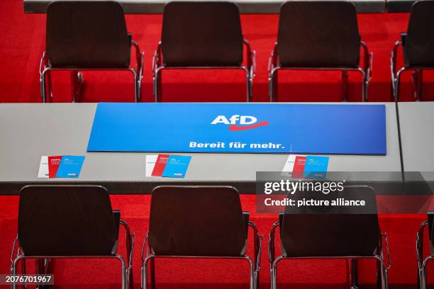 March 2024, Saxony, Glauchau: An "AfD ready for more" sign lies on a table in the Sachsenlandhalle ahead of the AfD state party conference. In the...