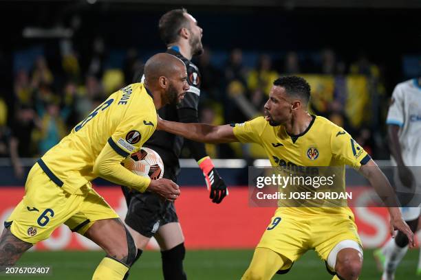 Villarreal's French midfielder Etienne Capoue celebrates with Villarreal's French midfielder Francis Coquelin scoring his team's first goal during...