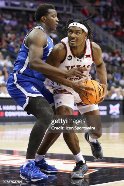 Brigham Young Cougars forward Fousseyni Traore guards Texas Tech Red Raiders forward Robert Jennings in the second half of a Big 12 tournament...