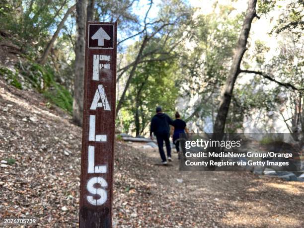 Carlos Gonzalez and Wendy Rodas head towards Switzer Falls in Angeles National Forest on Wednesday, March 13, 2024.