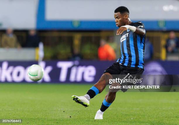 Club Brugge's Nigerian midfielder Raphael Onyedika shoots during the 2023-2024 UEFA Conference League round of 16 second leg football match between...