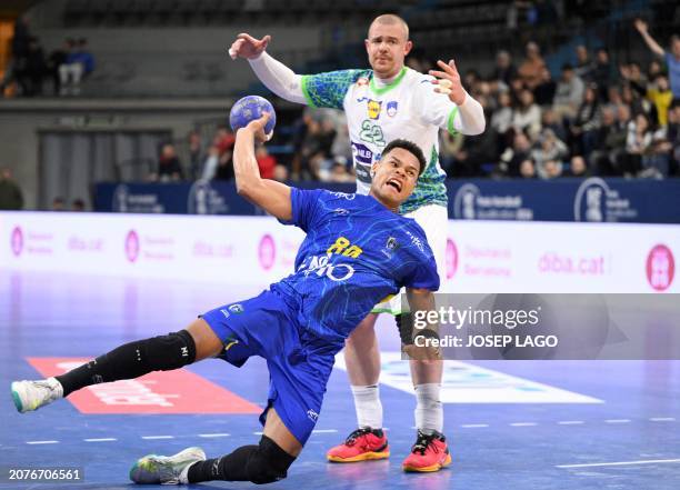 Brazil's pivot Edney Oliveira attemps a shoot next to Slovenia's pivot Matej Gaber during the qualifying handball match for the 2024 Paris Olympic...