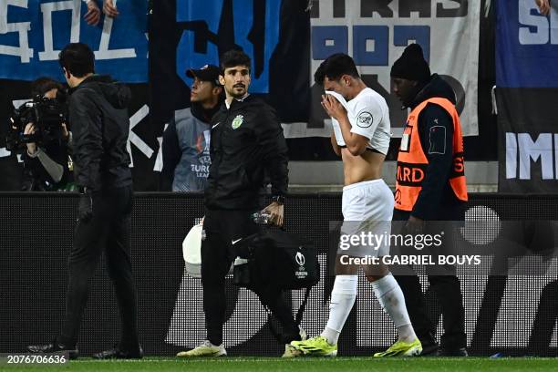 Sporting Lisbon's Portuguese midfielder Pedro Goncalves reacts as he leaves the pitch after an injury during the UEFA Europa League last 16 second...