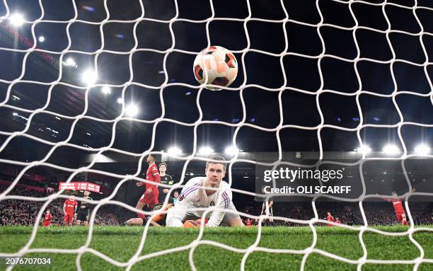 Sparta Praha's Danish goalkeeper Peter Vindahl Jensen concedes a fourth goal, scored by Liverpool's Dutch striker Cody Gakpo, during the UEFA Europa...