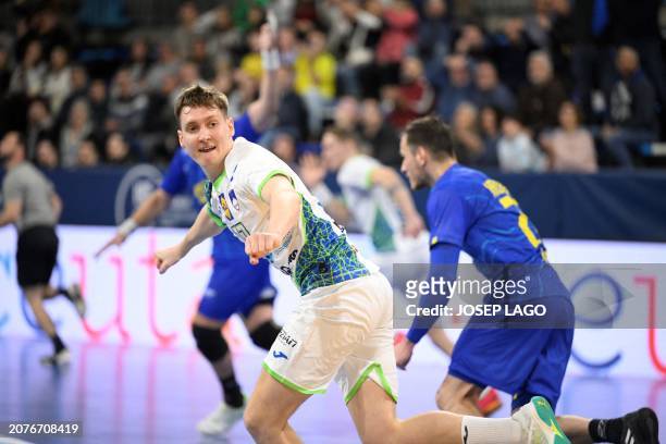 Slovenia's right wing Domen Novak celebrates scoring during the qualifying handball match for the 2024 Paris Olympic Games between Slovenia and...