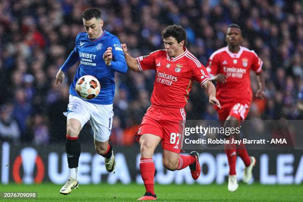 Tom Lawrence of Rangers and Joao Neves of Benfica during the UEFA Europa League 2023/24 round of 16 second leg match between Rangers FC and SL...