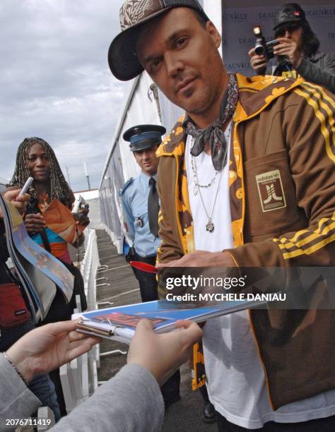 Photographer and director David LaChapelle signs autographs upon his arrival for a photocall of "Rize", presented at the 31st Deauville American Film...
