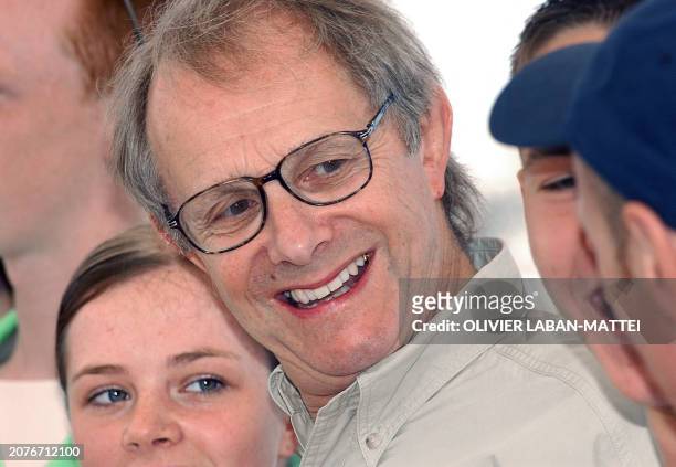 British director Ken Loach smiles as he poses for photographers with actors Annmarie Fulton and Martin Compston during the photocall for their film...