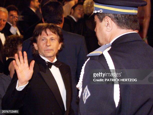 Director Roman Polanski waves to photographers as he arrives for the gala screening of "Fear and Loathing in Las Vegas" directed by Terry Gilliam, 15...