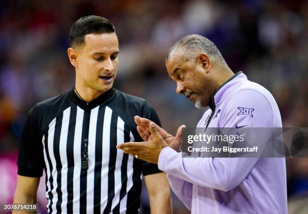 Referee Chance Moore talks with head coach Jerome Tang of the Kansas State Wildcats during the first half of a quarterfinal game of the Big 12 Men's...