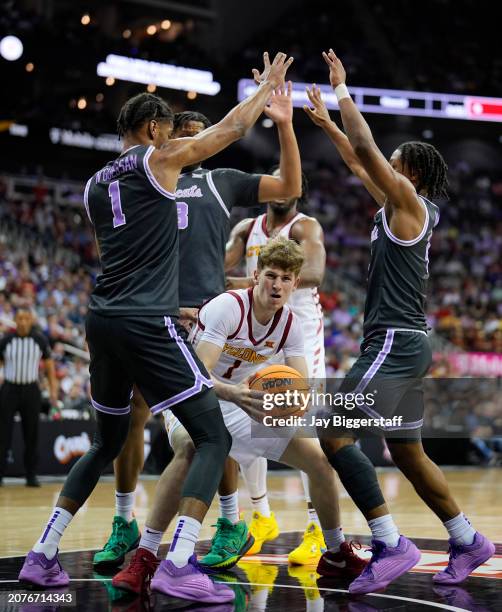 Jackson Paveletzke of the Iowa State Cyclones drives against David N'Guessan and Dai Dai Ames of the Kansas State Wildcats during the first half of a...