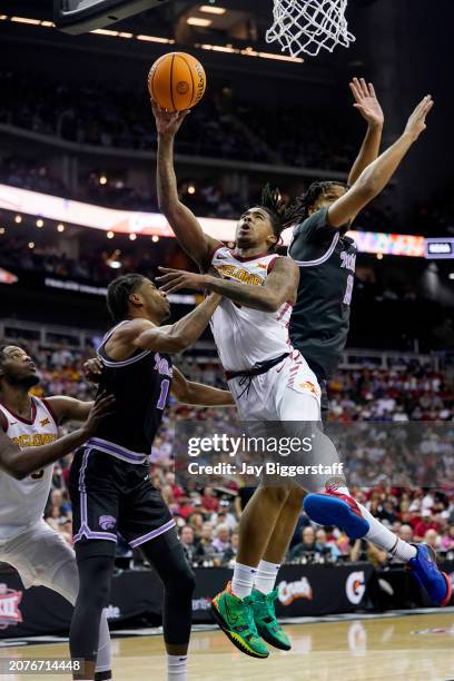 Keshon Gilbert of the Iowa State Cyclones shoots against David N'Guessan and Will McNair Jr. #13 of the Kansas State Wildcats during the first half...