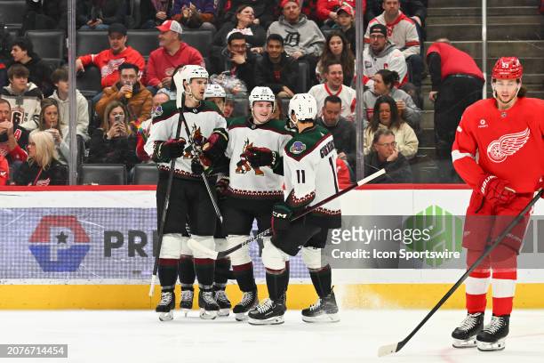 Arizona Coyotes center Logan Cooley celebrates his goal in the first period with his linemates during the game between the Detroit Red Wings and the...