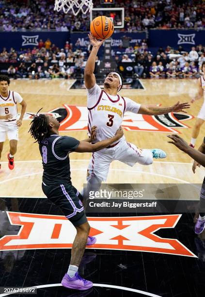 Tamin Lipsey of the Iowa State Cyclones shoots against R.J. Jones of the Kansas State Wildcats during the second half of a quarterfinal game of the...