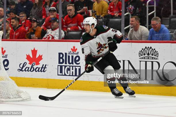 Arizona Coyotes defenseman Sean Durzi brings the puck up ice from behind his own net during the game between the Detroit Red Wings and the Arizona...