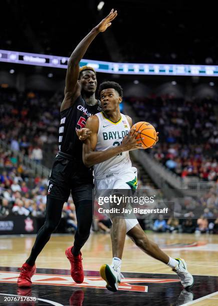 Yves Missi of the Baylor Bears drives against Aziz Bandaogo of the Cincinnati Bearcats during the first half of a quarterfinal game of the Big 12...