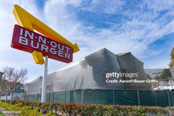 General views of In-N-Out Burger on Sunset Blvd closed and tented for termite fumigation on March 13, 2024 in Hollywood, California.